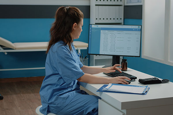 A nurse looking up information on a computer