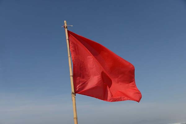 A red flag waving in the wind