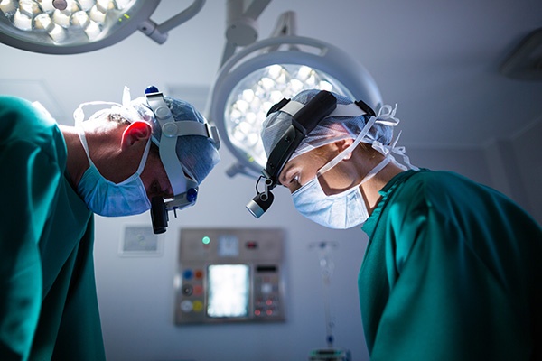 A CRNA and a doctor looking down in an operating room