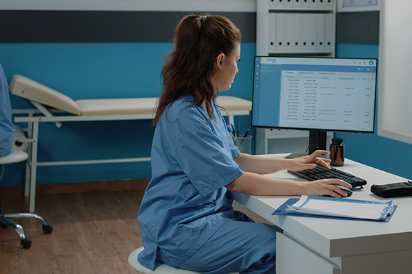 A nurse reviewing information on a computer