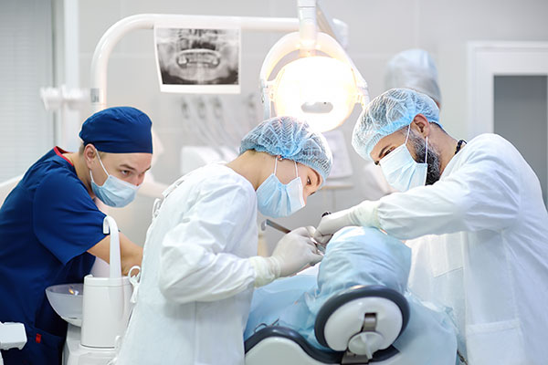 Certified Registered Nurse Anesthetist, a doctor and a nurse operating on a patient 