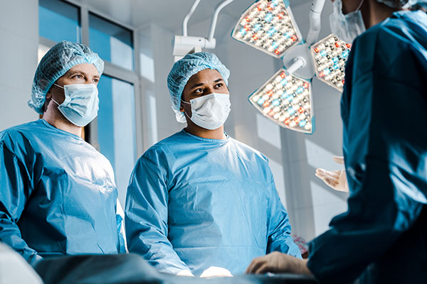 A nurse anesthetist and other nurses talking in an operating room