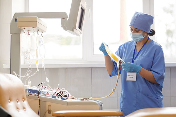 A nurse anesthetist reviewing medications in a IV