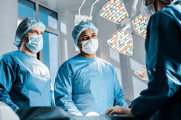 Medical professionals wearing masks in an operating room