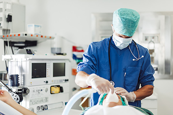 A nurse anesthetist taking care of a patient in an operating room