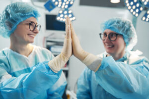Two nurses high-fiving each other