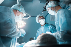a CRNA and surgeons around a patient in an operating room