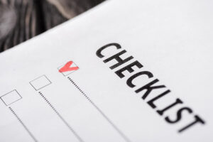A closeup view of a checklist with a red checkmark on it