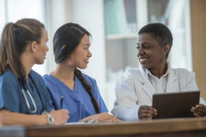 A nurse mentoring two other nurses