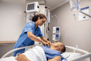 An ICU nurse helping their patient