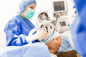 A nurse anesthetist putting a patient under anesthesia 